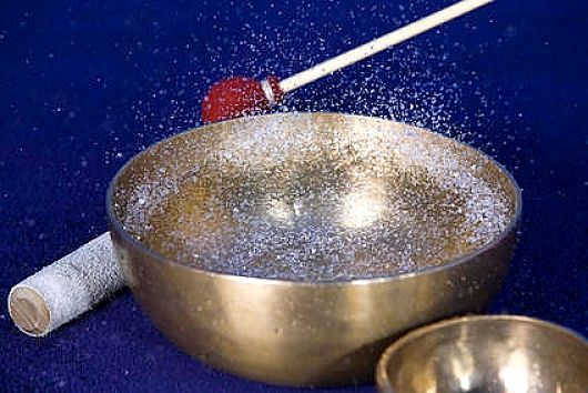 Dancing droplets in Tibetan Singing bowl